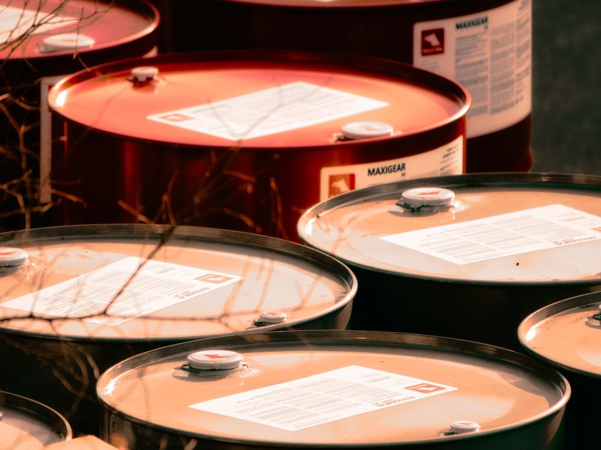 Lubricant oil drums in warm warehouse light